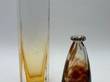 a glass vase and a glass vase on a table
