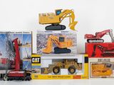 a lot of toy construction vehicles on display on the table