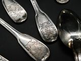 several silver spoons and spoon spoons on a black surface