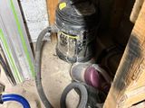 an image of a room that has a hose and other items on the floor