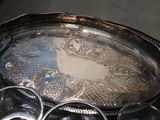 a silver tray with silver cups on it on a table