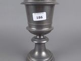 an image of a silver vase with a number on it