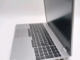 a silver laptop with a black keyboard on a white surface