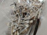 a bag of silverware on a table with a knife and fork