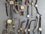 a lot of watches that are sitting on a table