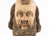 a wooden bust of a man with a beard