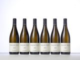 six bottles of white wine lined up in a row