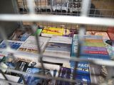 a cage filled with books and magazines in a store