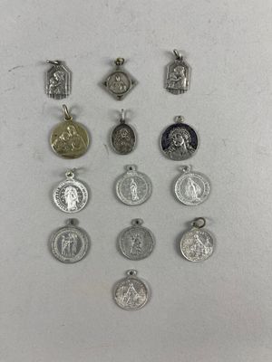 a close up of a group of silver and gold medals on a white surface