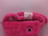 pink teddy bear purse with a white ribbon on top of it