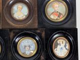 four framed miniature portraits of women and men in black frames
