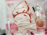 a stuffed animal in a plastic bag with a tennis racket