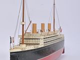 a model of a large ship on a white surface