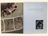 an open book with a picture of a woman and flowers on it