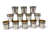 six silver shot glasses are stacked on top of each other