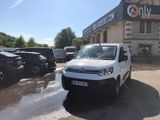 a white van that is parked in front of a building