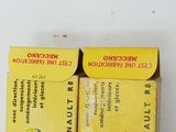 two boxes of cigarettes sitting on a white surface