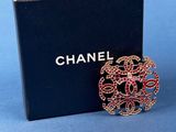 a close up of a box with a brooch on it