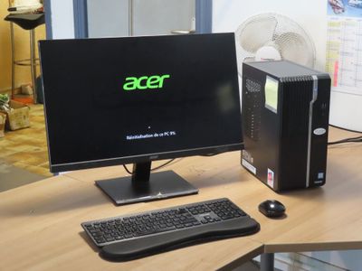 a desktop computer sitting on a desk with a keyboard and mouse