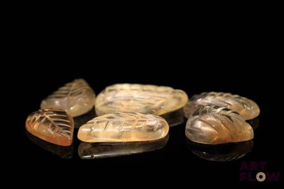 four pieces of carved soap sitting on top of a black surface