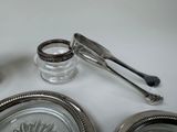 a silver plate with a spoon and a glass jar on it