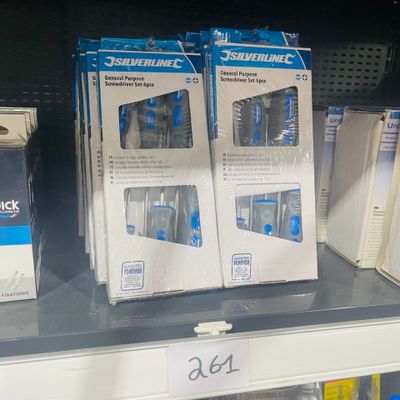 boxes of toothbrushes are on a shelf in a store