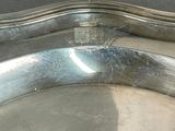 a silver tray with a handle on a table