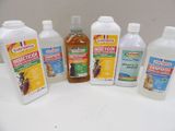 five bottles of insect repellent sitting on a table