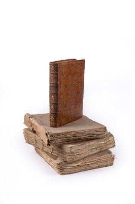 books stacked on top of each other on a white surface