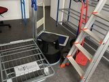 several ladders and a table in a room with a desk and a chair