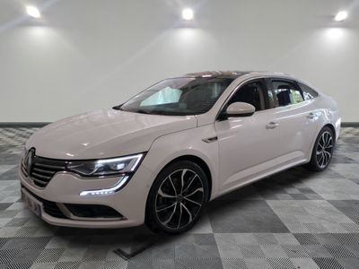 the white car is parked on a checkered floor in a room