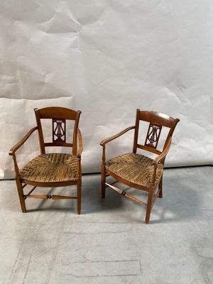 une paire de chaises en bois aux assises tressées, sur fond blanc