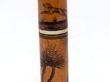 a tall glass vase with a picture of a bird on it