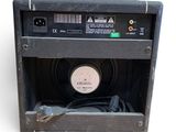 a black amp sitting on top of a white surface