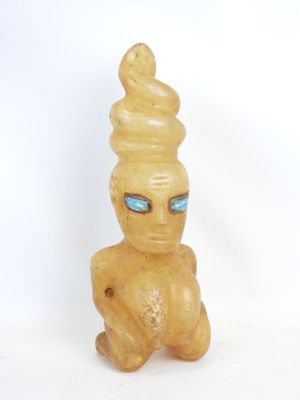 a small statue of a man with a cone on his head