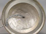 a silver bowl with a wire in it on a table