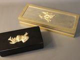 a black box with a gold design on it and a black box with a gold design on it