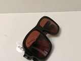 a pair of sunglasses on a table with a sticker on it