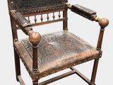 a wooden chair with a leather seat on it