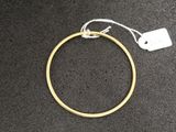 a close up of a gold ring with a tag on it
