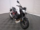 a motorcycle that is parked in a room with a checkered floor