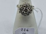silver ring with black stones and a price tag on top of a cone