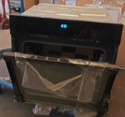 une photo d'un micro-ondes posé sur un chariot dans une pièce