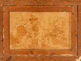an old picture of a wooden frame with a picture on it