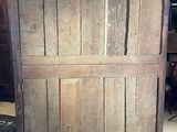 an old wooden cabinet that is in the middle of a room