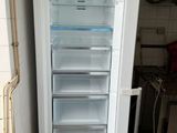a white refrigerator with its door open in a kitchen
