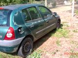 a green car that is parked in the grass