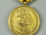 an image of a gold medal with a ribbon around it