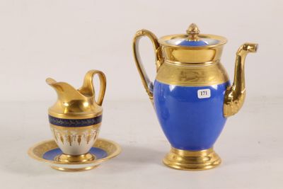 a blue and gold coffee pot and cup on a table