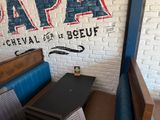 a laptop sitting on a table in front of a brick wall